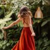 a woman in a red dress is walking