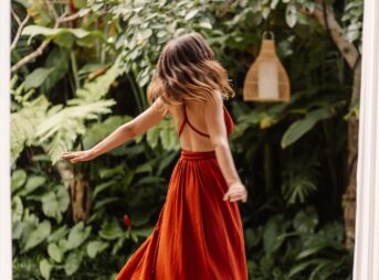 a woman in a red dress is walking