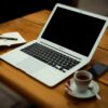 MacBook Air on brown wooden table