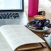 a coffee cup and a pen on a desk