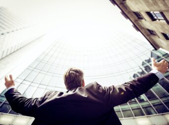 low-angle photography of man in the middle of buidligns