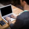 man in front of laptop computer in shallow focus photography