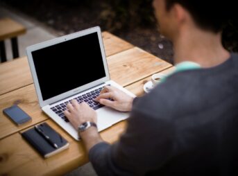 man in front of laptop computer in shallow focus photography