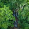 an aerial view of a waterfall surrounded by trees