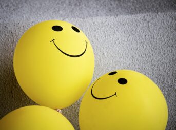 yellow smiley emoji on gray textile