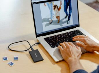 A person using a laptop computer on a table