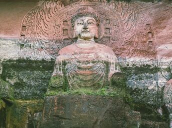 A group of buddha statues sitting next to each other